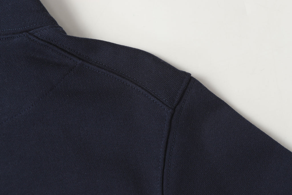 Navy quarter-zip sweatshirt with side seam and clean stitch detailing.