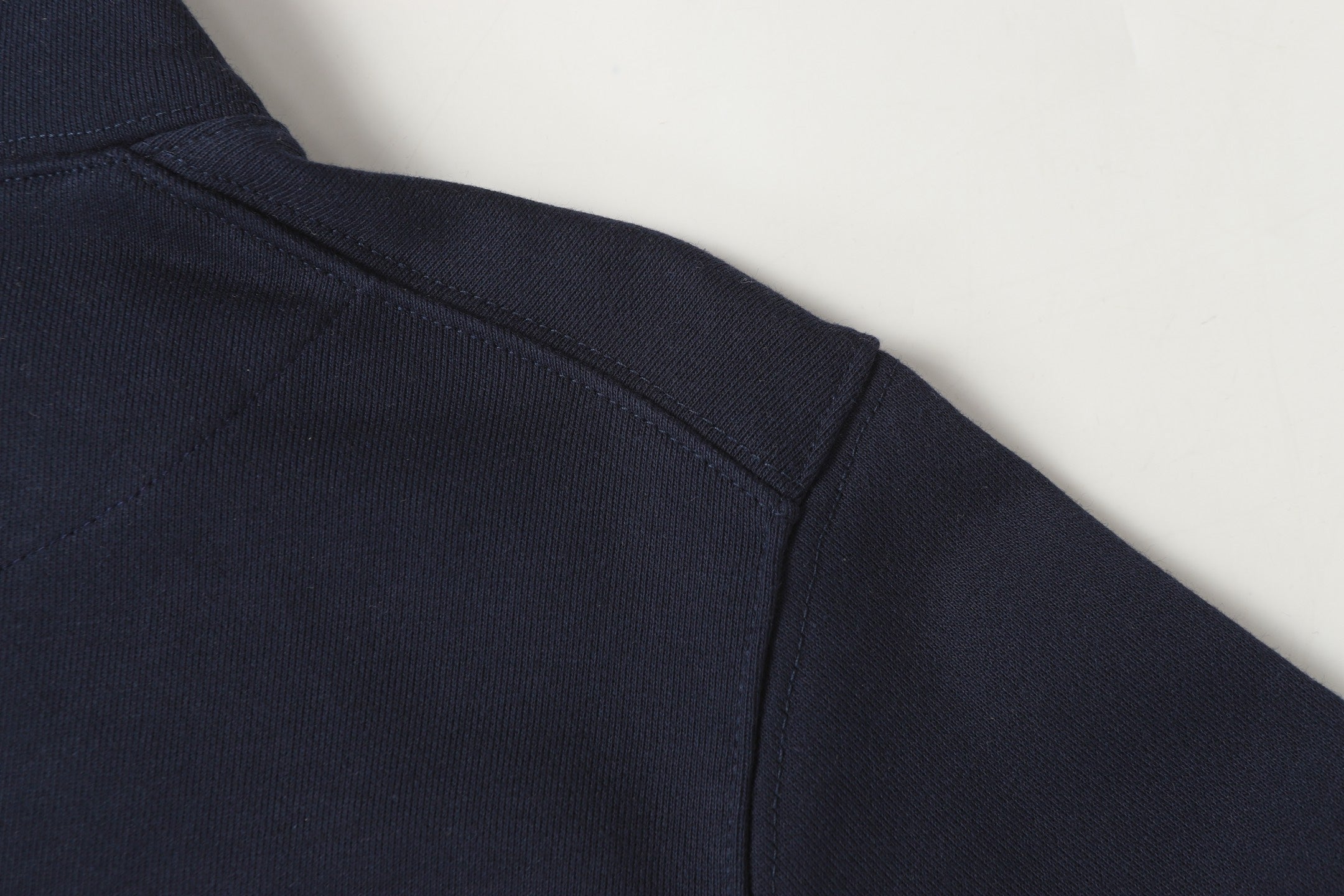 Navy quarter-zip sweatshirt with side seam and clean stitch detailing.