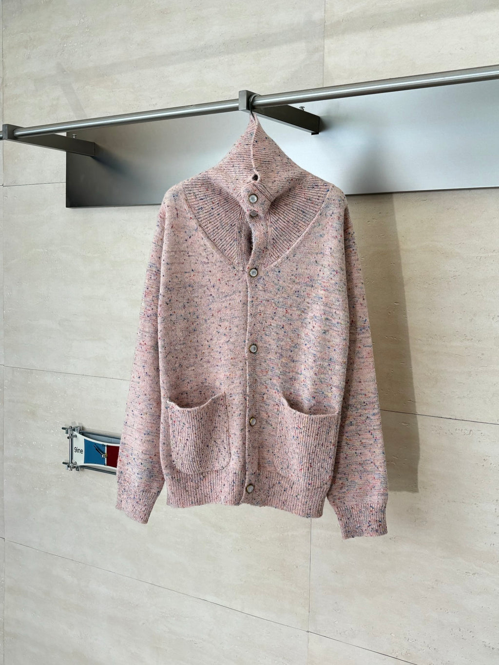 Pink speckled knit cardigan sweater with button front and stand collar, long sleeves