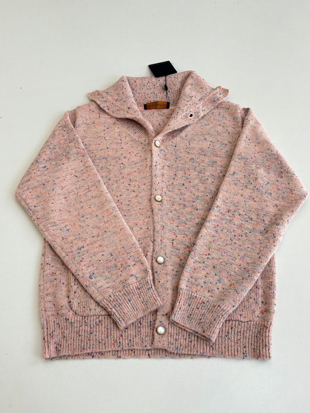 Pink speckled knit cardigan sweater with button front, textured knit collar, long sleeves