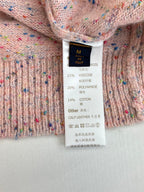 Clothing size and fabric composition label on pink speckled knit cardigan sweater
