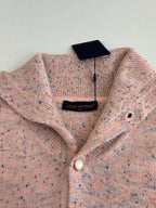 Louis Vuitton knit cardigan close-up with V-neck, pearl button, and neck label
