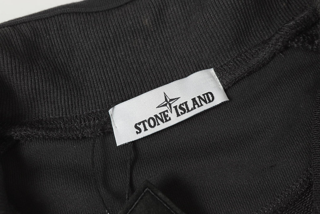 Stone Island dark trousers with logo label and waistband patch