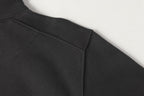 Black half-zip sweatshirt waistband and side seam detail