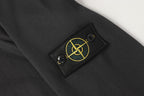 Stone Island dark trousers with emblem patch and metal eyelets