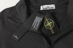 Black half-zip sweatshirt close-up with zipper pull and interior brand label