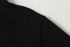 Black sweatshirt with visible stitching along front seam