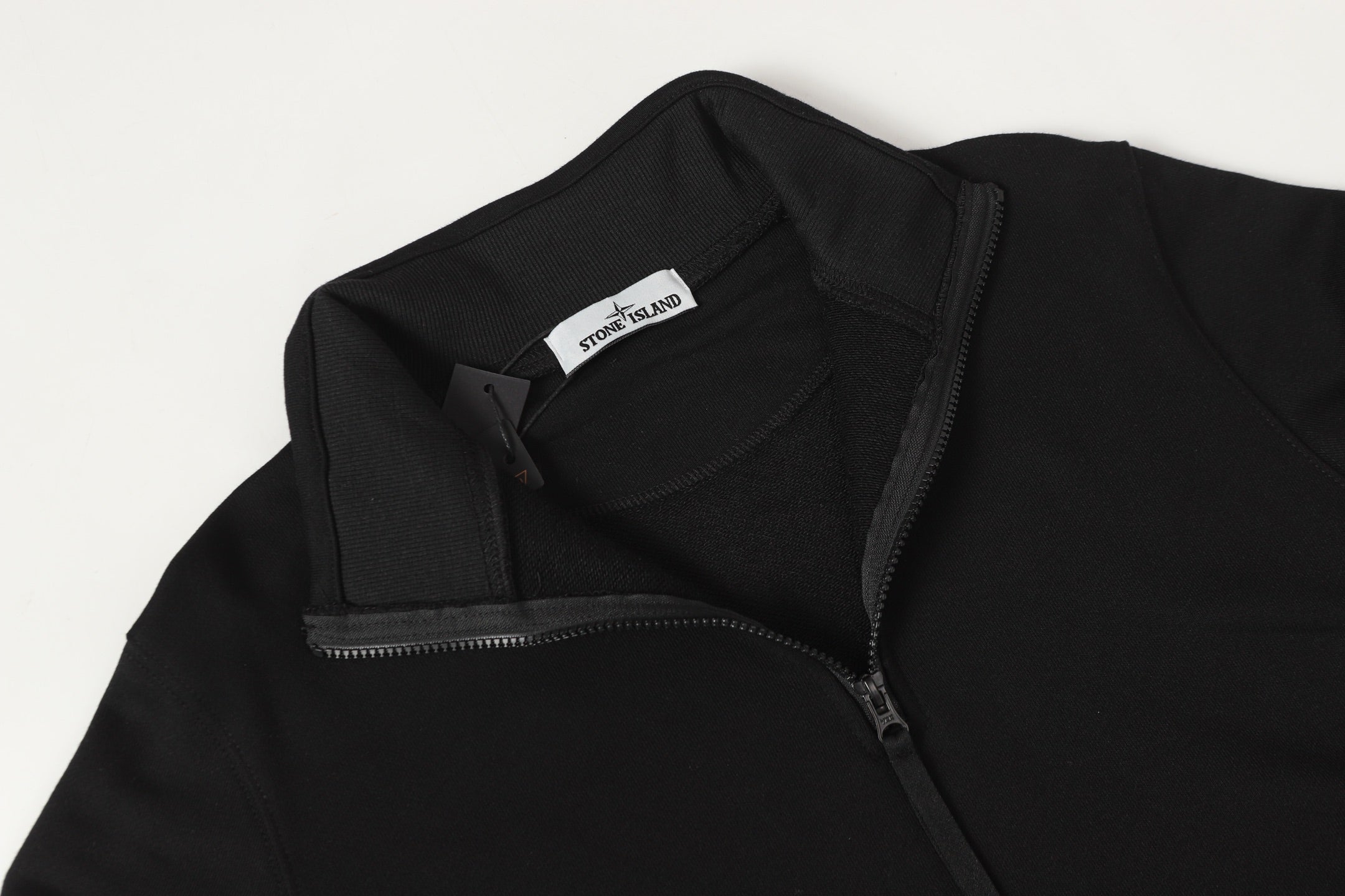 Black quarter-zip sweatshirt with neck label and front zipper