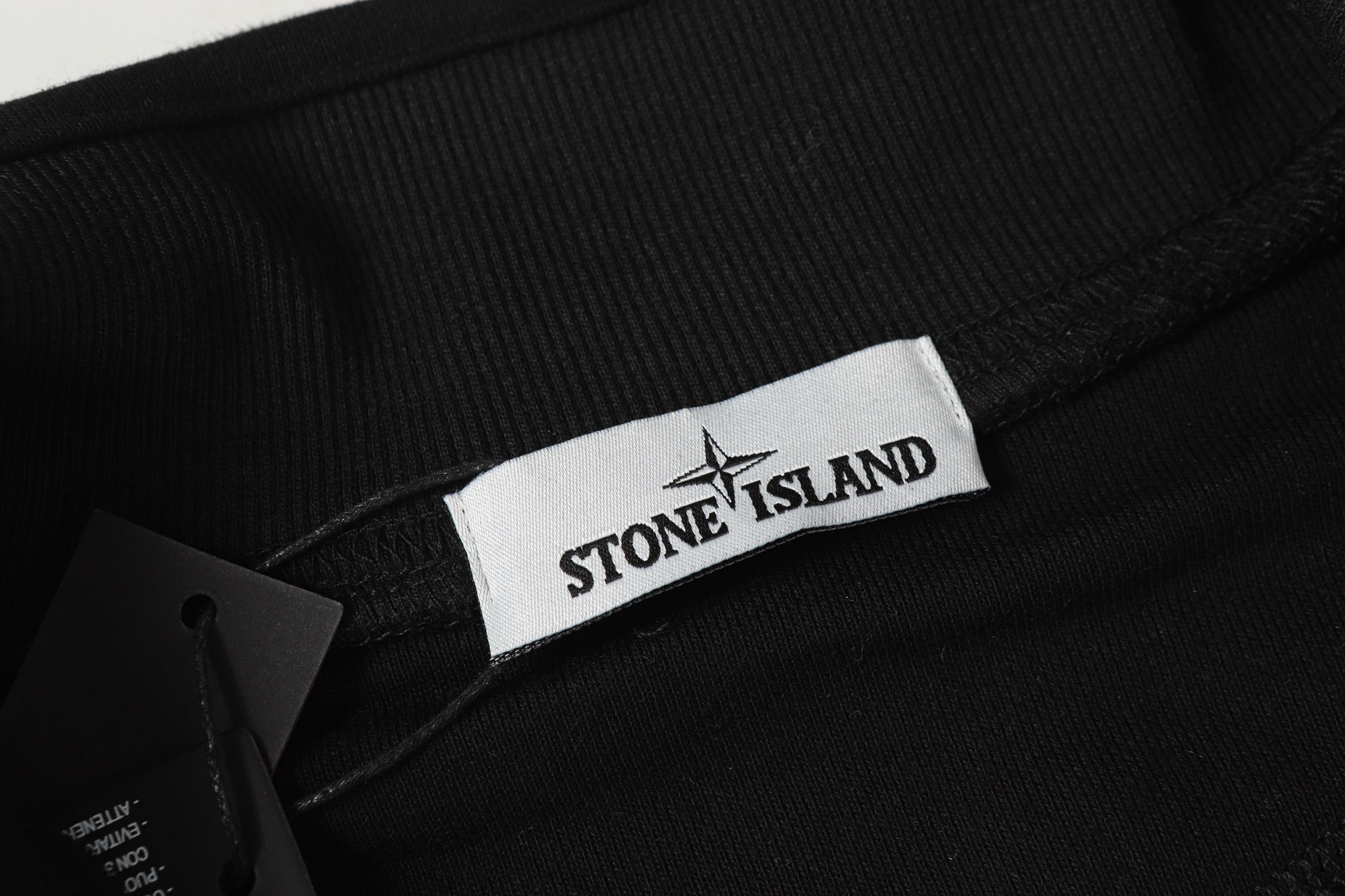 Black sweatshirt with Stone Island logo label at the neckline