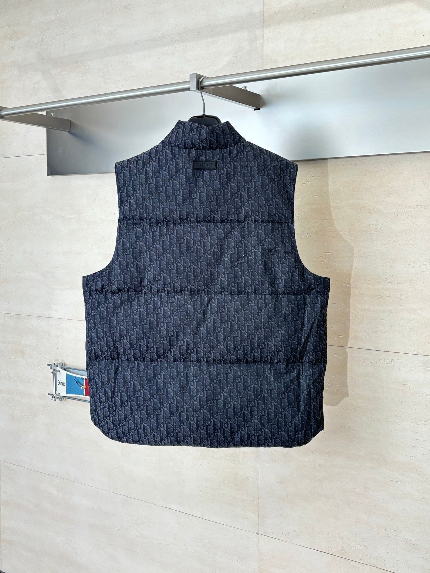 Quilted sleeveless vest with stand collar, dark Dior monogram pattern, patch pockets.
