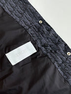 Dark Dior monogram vest with button fastening and white Dior logo patch detail.
