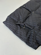 Sleeveless quilted vest in dark Dior monogram fabric, stand collar and button placket detail.