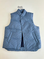 Blue sleeveless padded vest with stand collar, front buttons, and chest pocket flaps