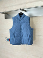 Blue sleeveless padded vest with stand collar and front button placket, on hanger