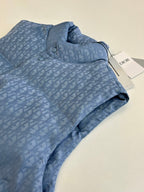 Folded light blue sleeveless vest with Dior-style monogram pattern, collar and snap