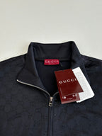 Gucci zip jacket with dark navy monogram, metal zipper, stand collar