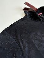 Gucci jacket detail: dark navy monogram pattern on shoulder and sleeve