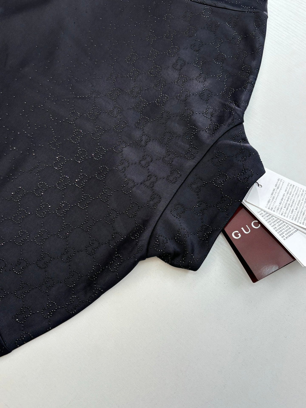 Gucci jacket fabric detail in dark navy with subtle monogram and side panel seam