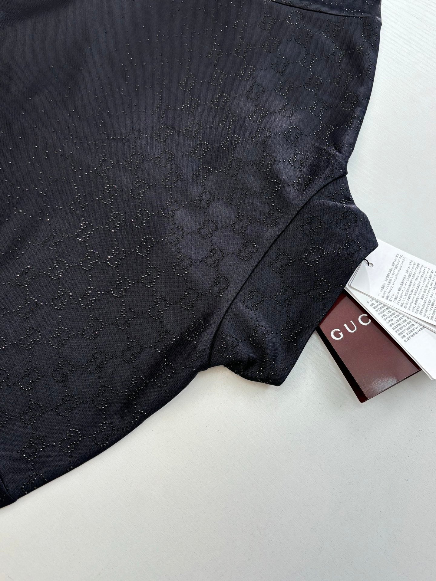 Gucci jacket fabric detail in dark navy with subtle monogram and side panel seam
