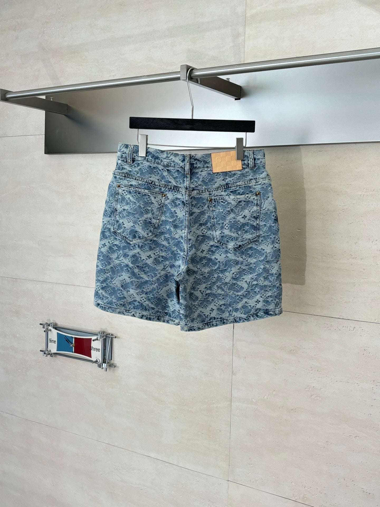 Blue monogram denim shorts with belt loops and front zipper fly