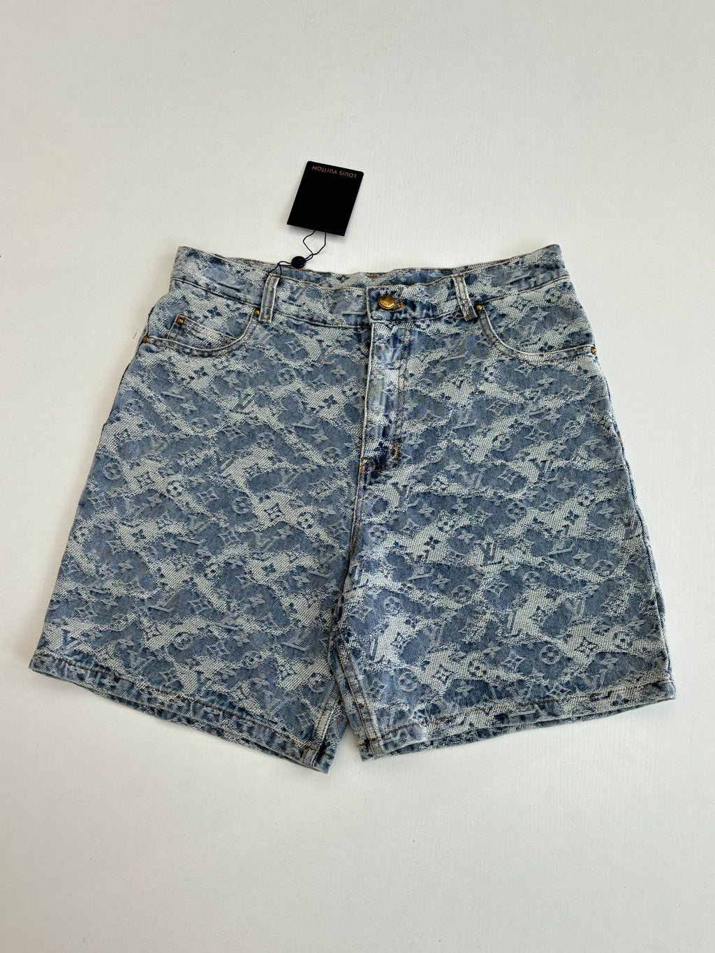 Blue monogram denim shorts, front view with gold button and fly
