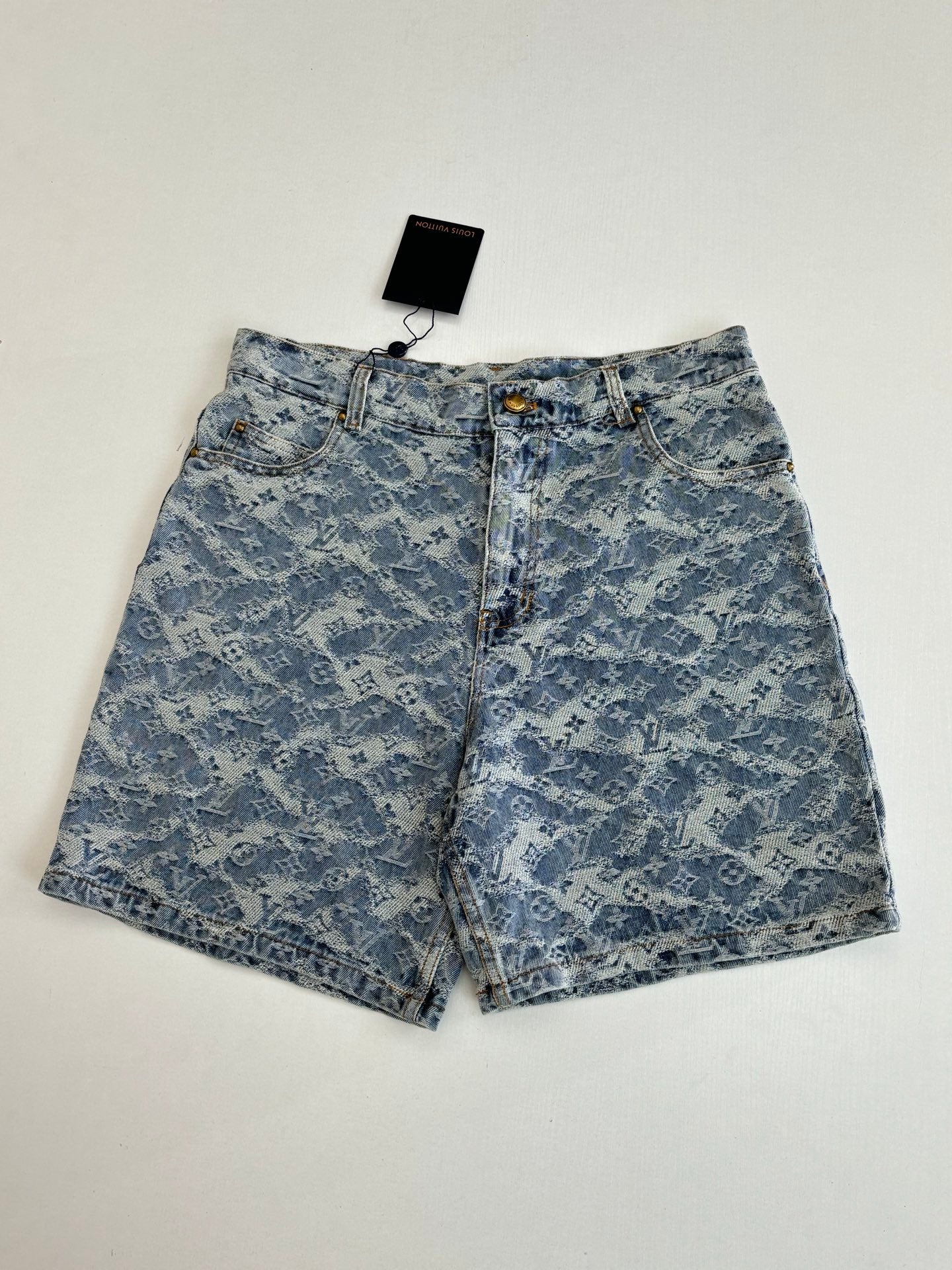 Blue monogram denim shorts, front view with gold button and fly