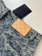 Blue monogram denim shorts with tan leather tag and gold-tone buttons