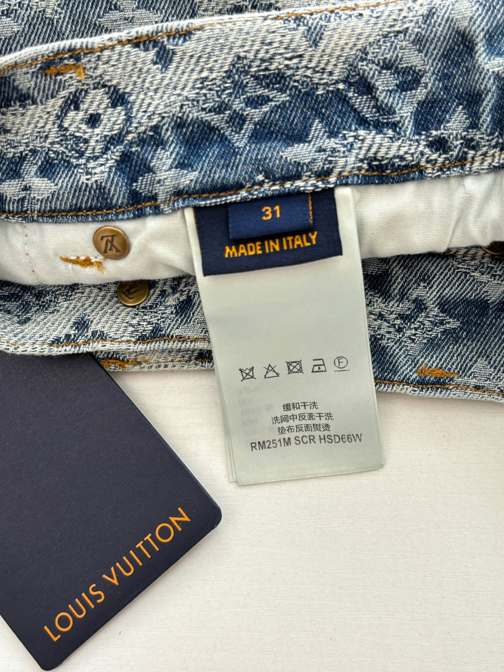 Denim shorts inner tag showing size 31, Made in Italy and care symbols