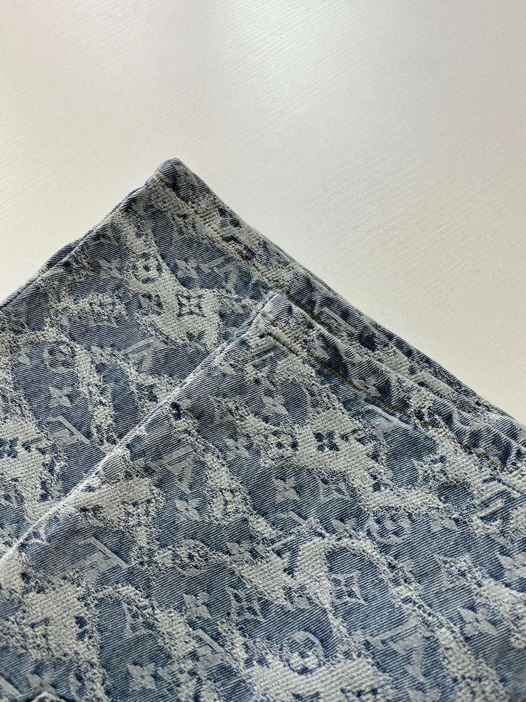 Blue monogram denim shorts with textured fabric and patterned weave