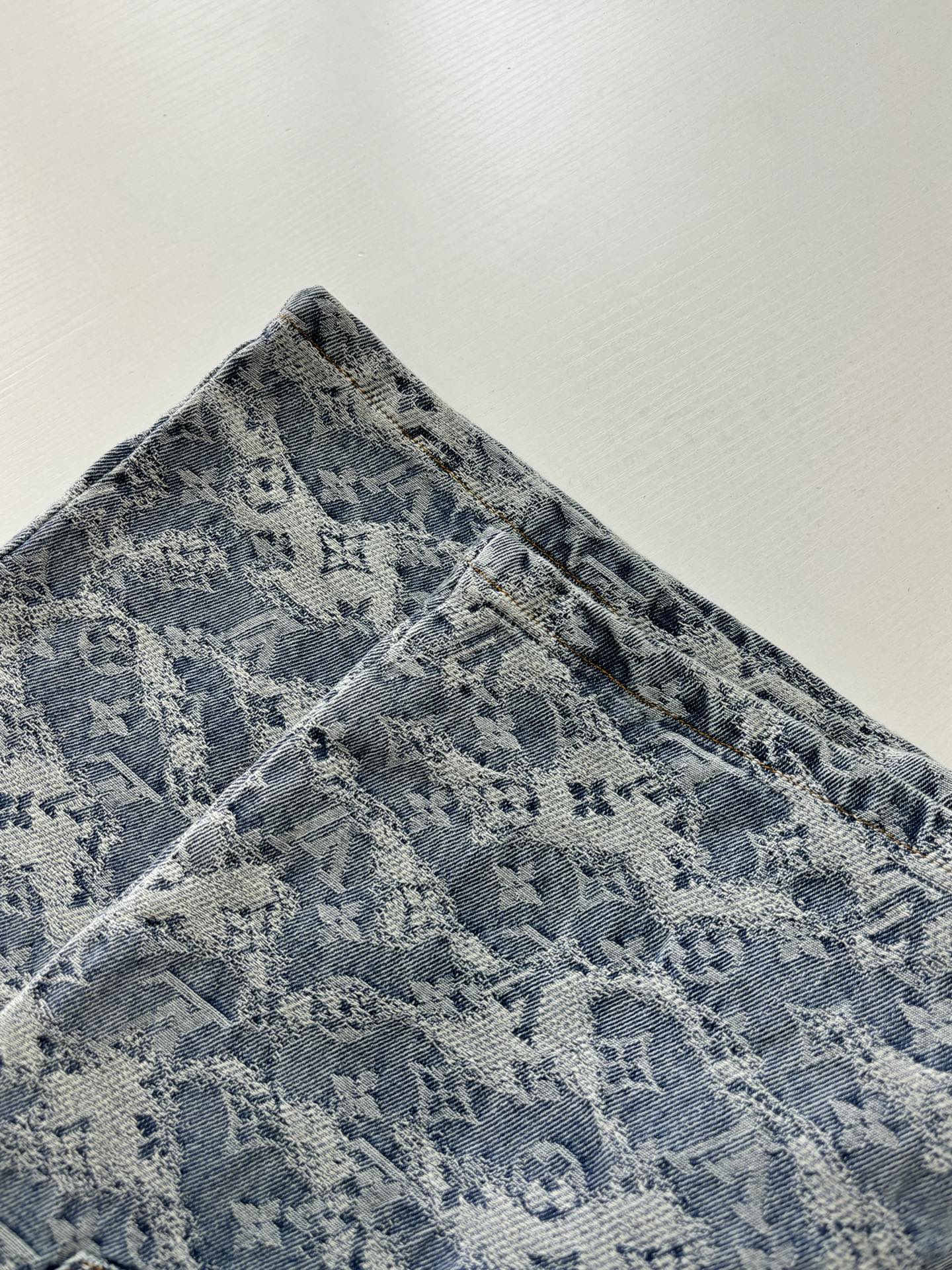 Blue monogram denim shorts with textured fabric and patterned weave