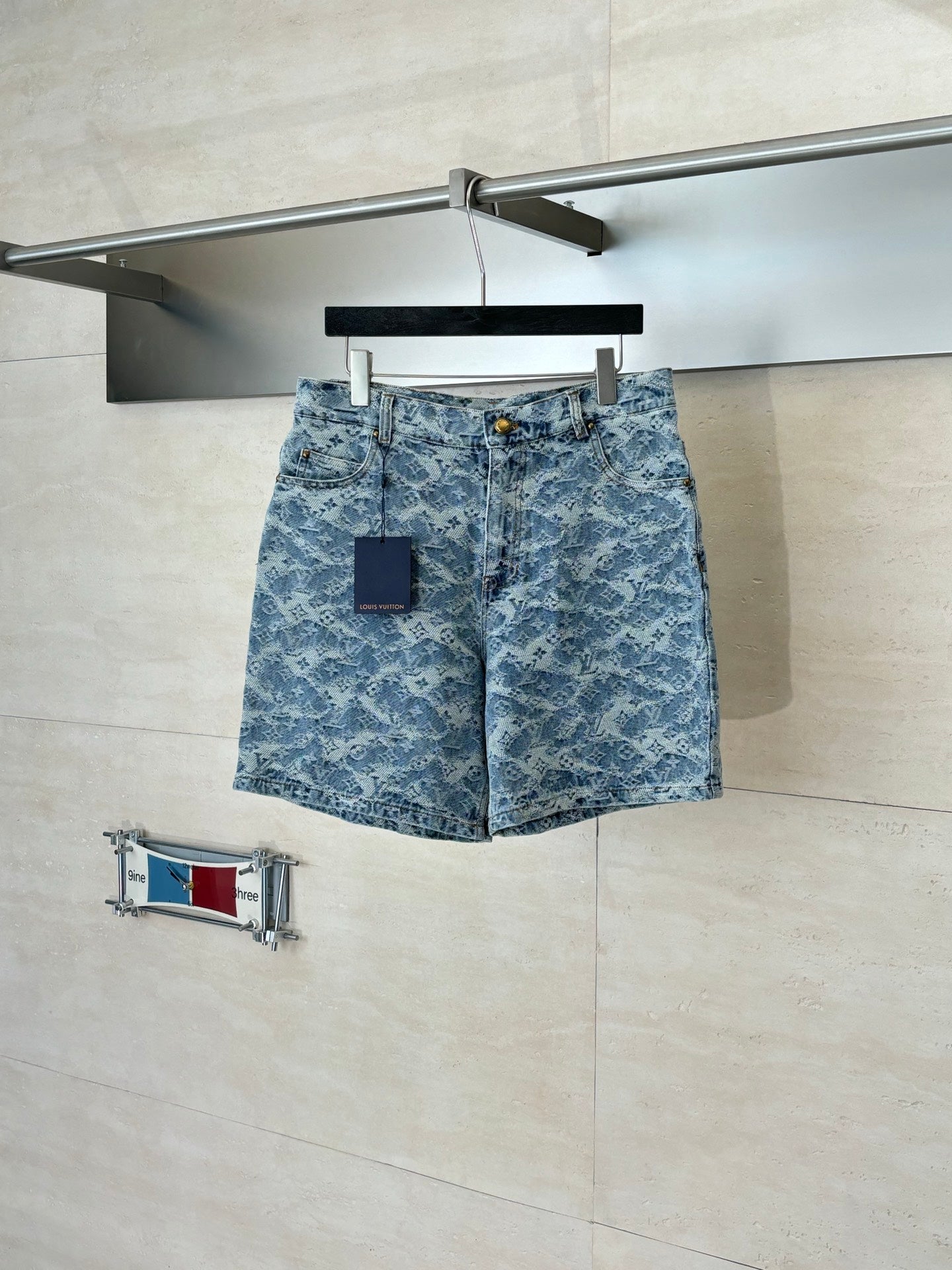 Blue monogram denim shorts with button closure and side pockets