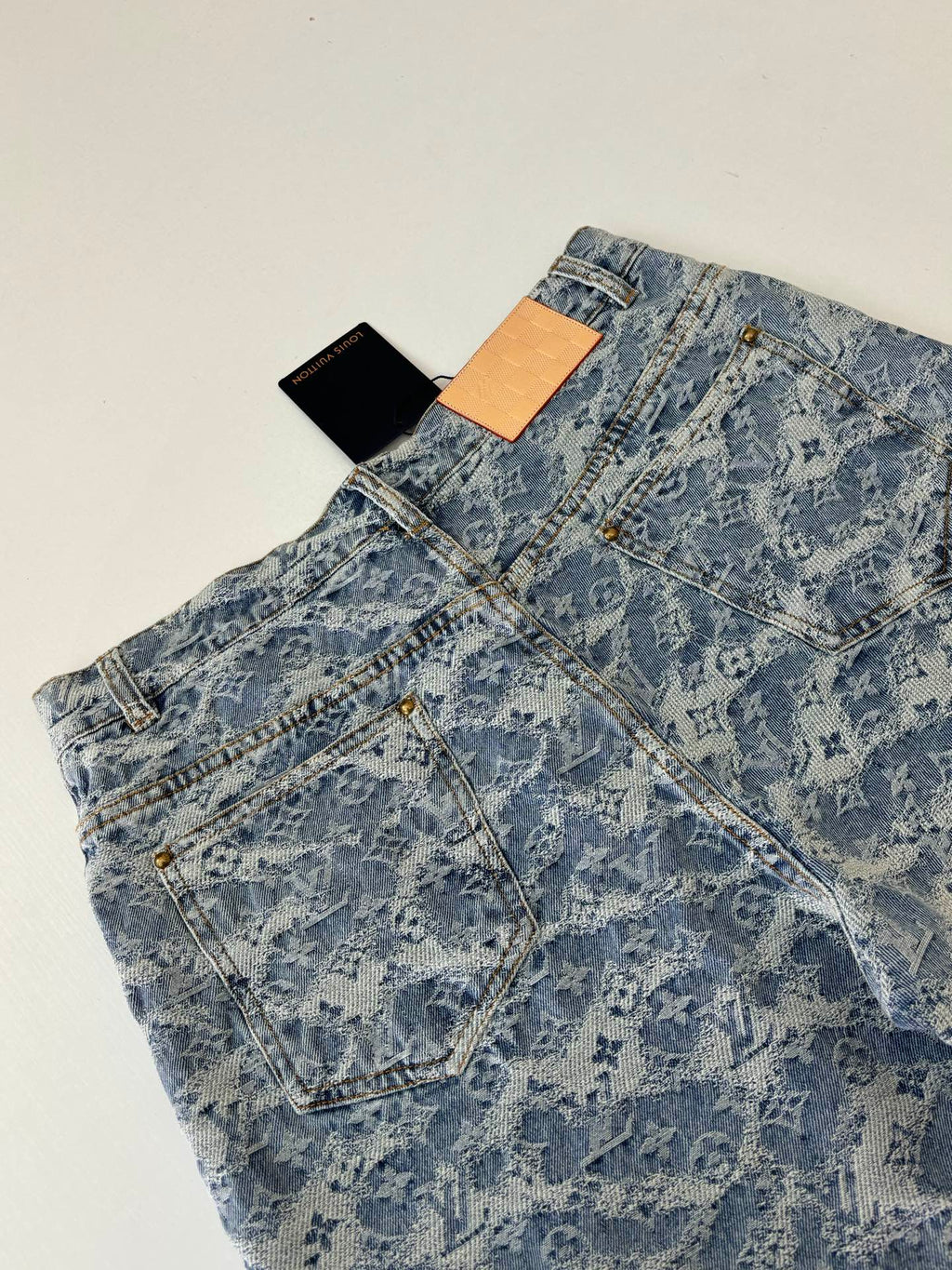 Blue monogram denim shorts with front pockets and removable hang tags