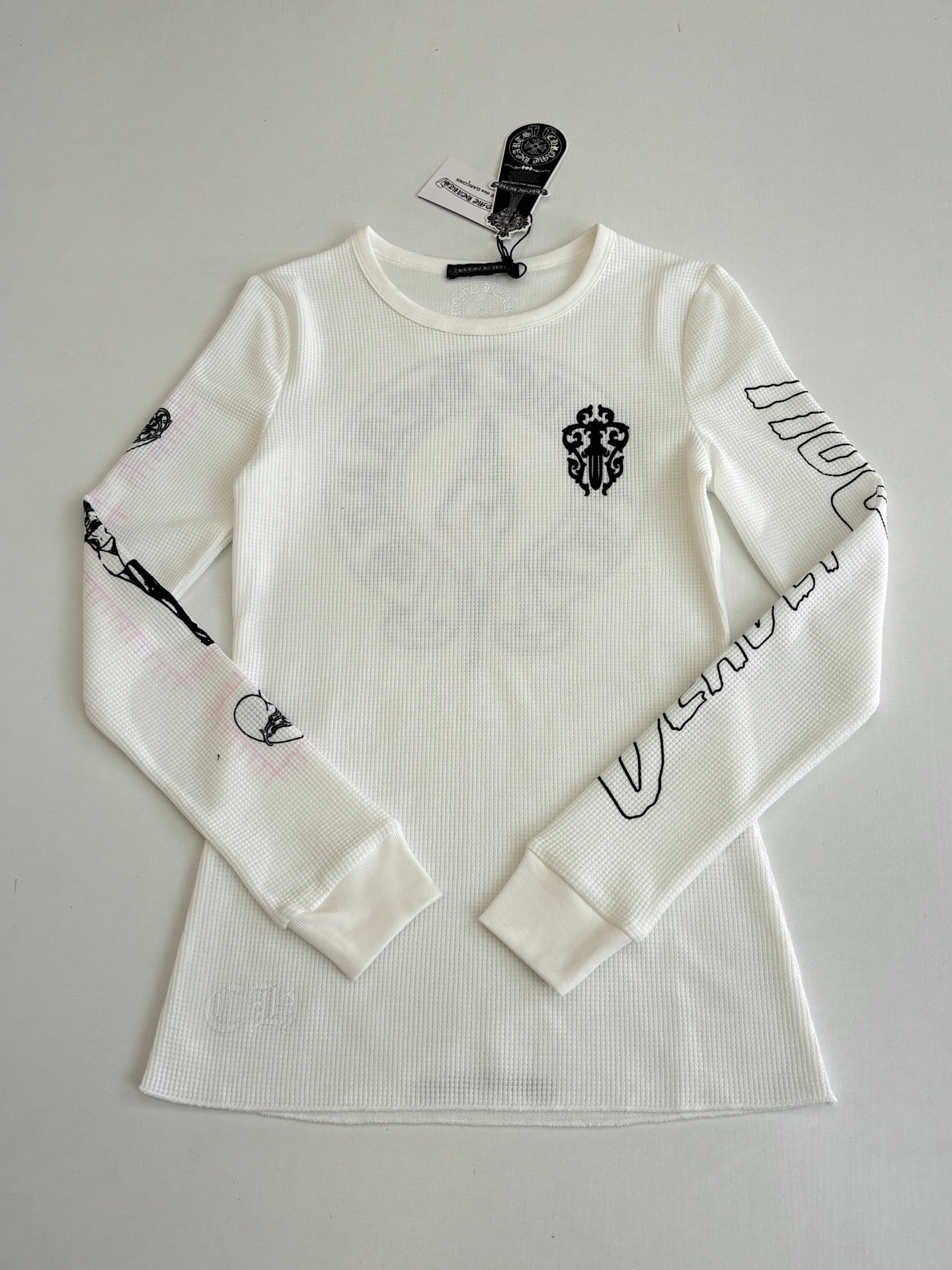 White long-sleeve crewneck shirt with small front emblem and sleeve band print