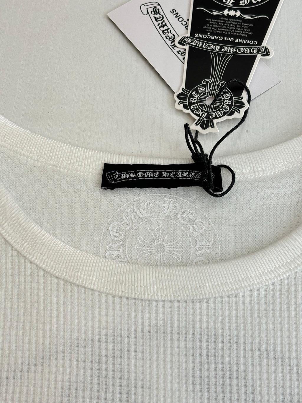 White crewneck shirt collar with black neck label and drawstring tag