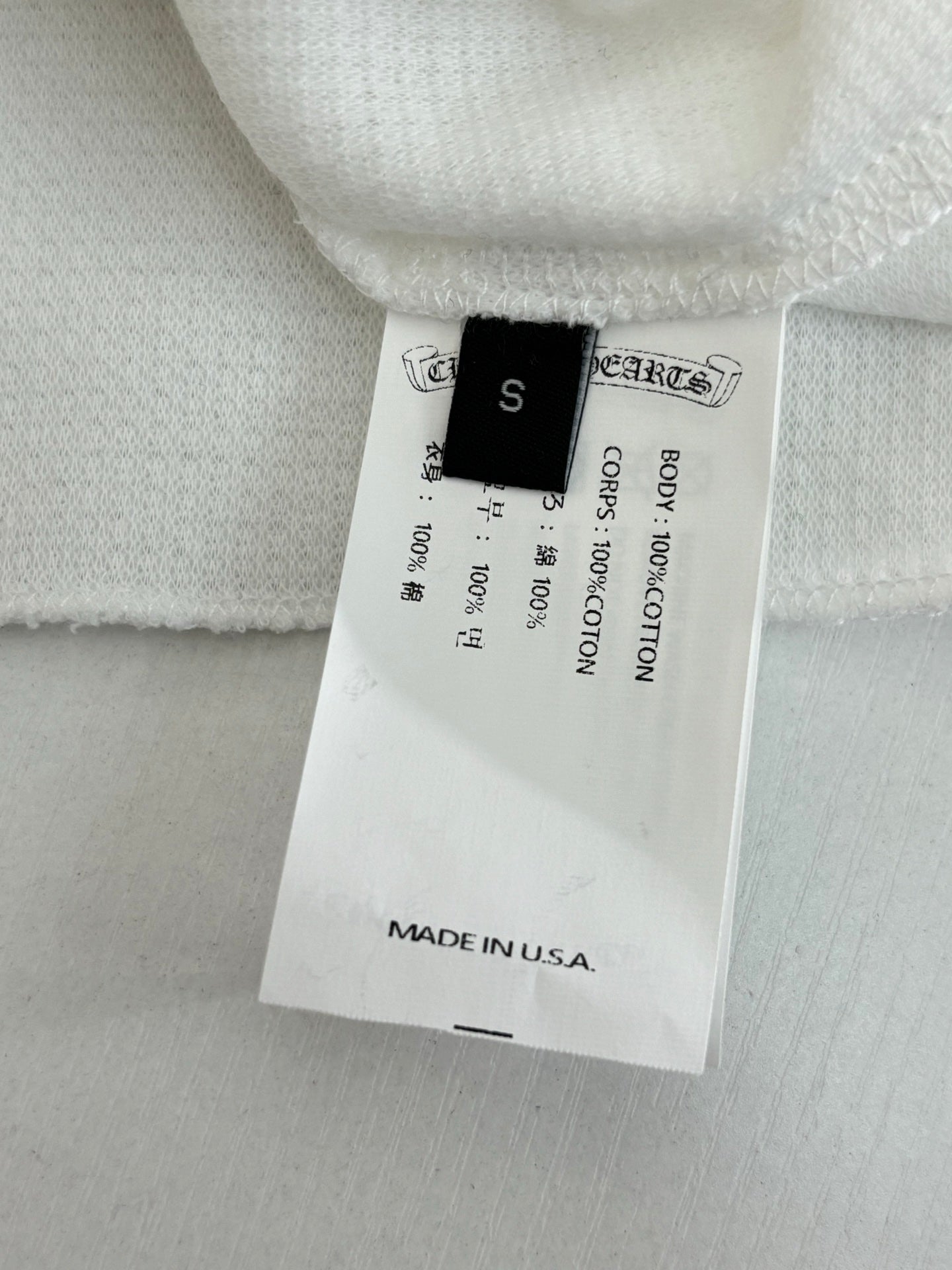White shorts with fabric tag showing size S and Made in USA