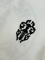 White long-sleeve shirt fabric with black lion emblem patch