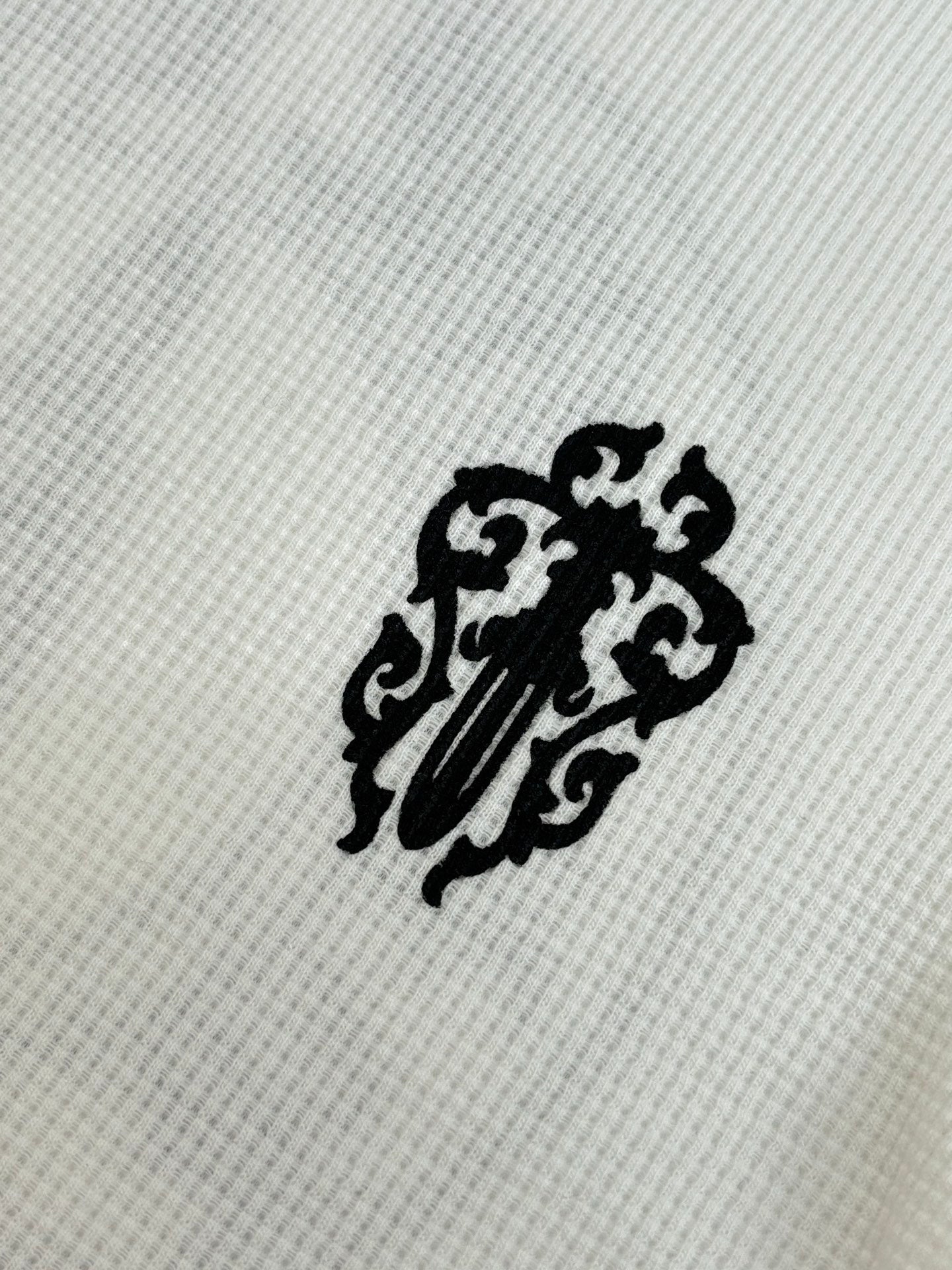 White long-sleeve shirt fabric with black lion emblem patch