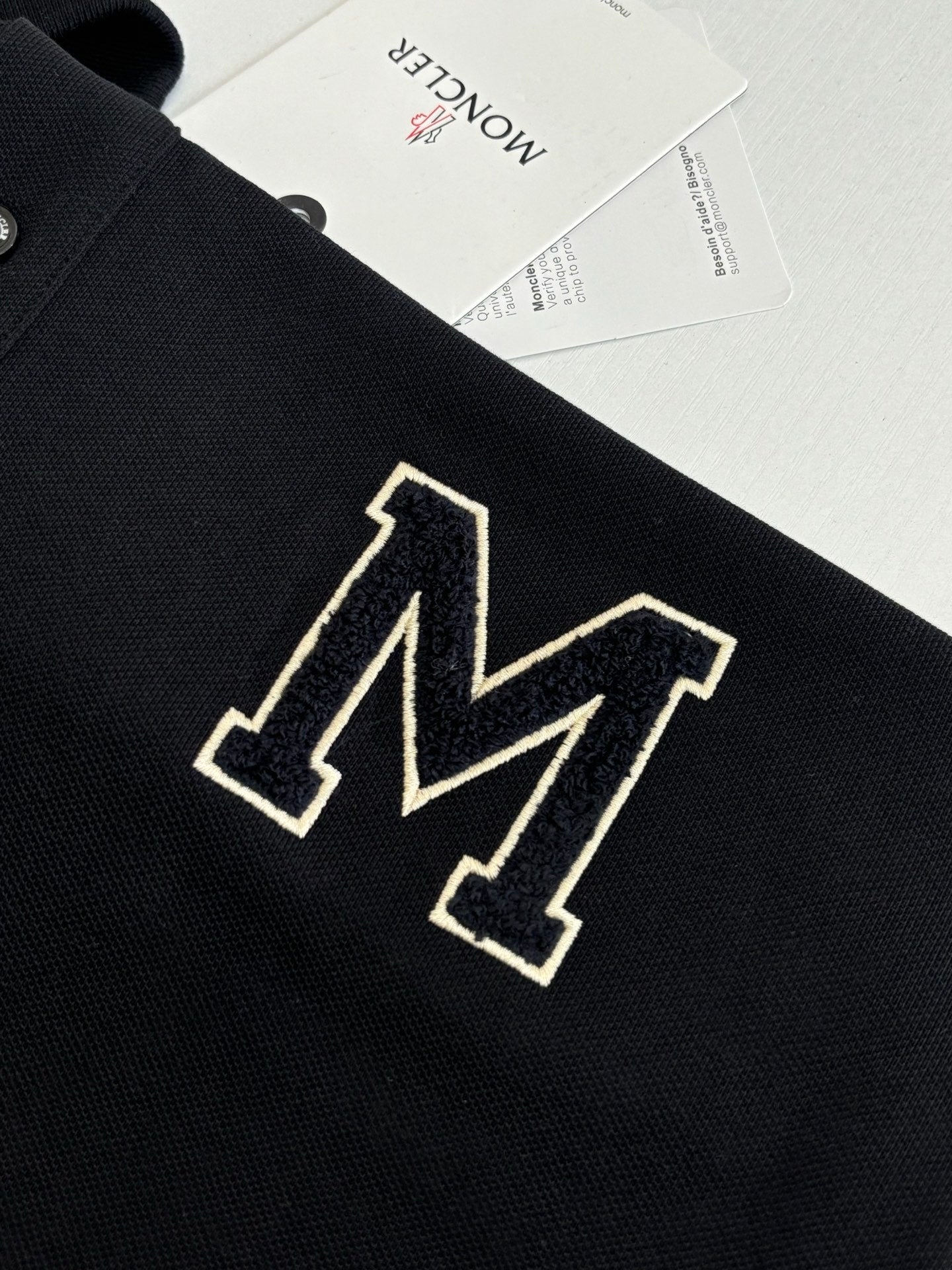 Moncler polo shirt chest logo, dark navy with outlined geometric M emblem