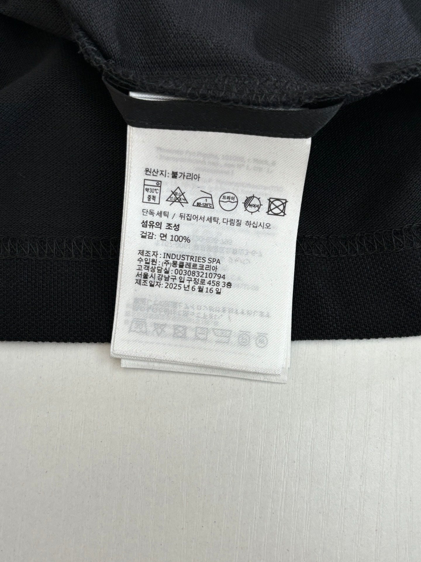 Moncler polo shirt care label and size tag on inner neck, dark navy