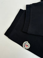 Moncler polo shirt side view, dark navy with small circular logo patch