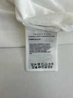 White polo shirt care label with fabric and washing symbols