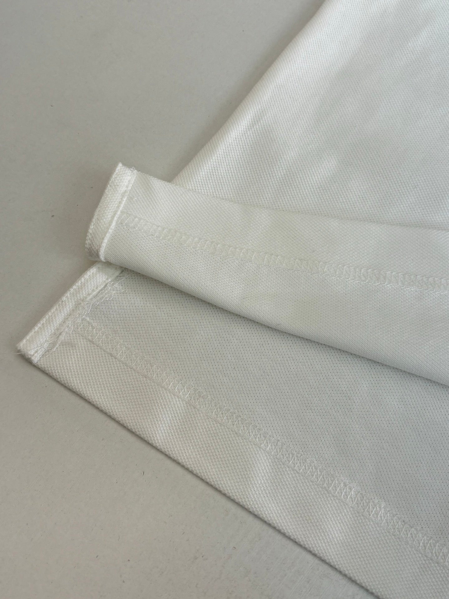 White polo shirt sleeve hem and cuff detail