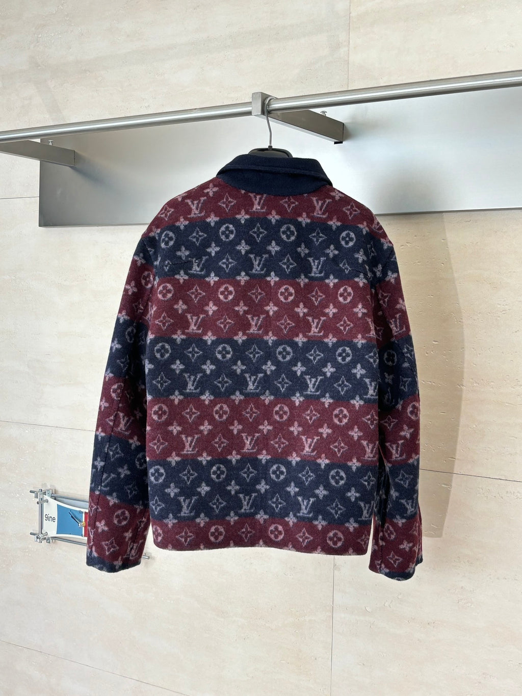 Long Louis Vuitton jacket with maroon and navy monogram pattern, back view, stand collar.
