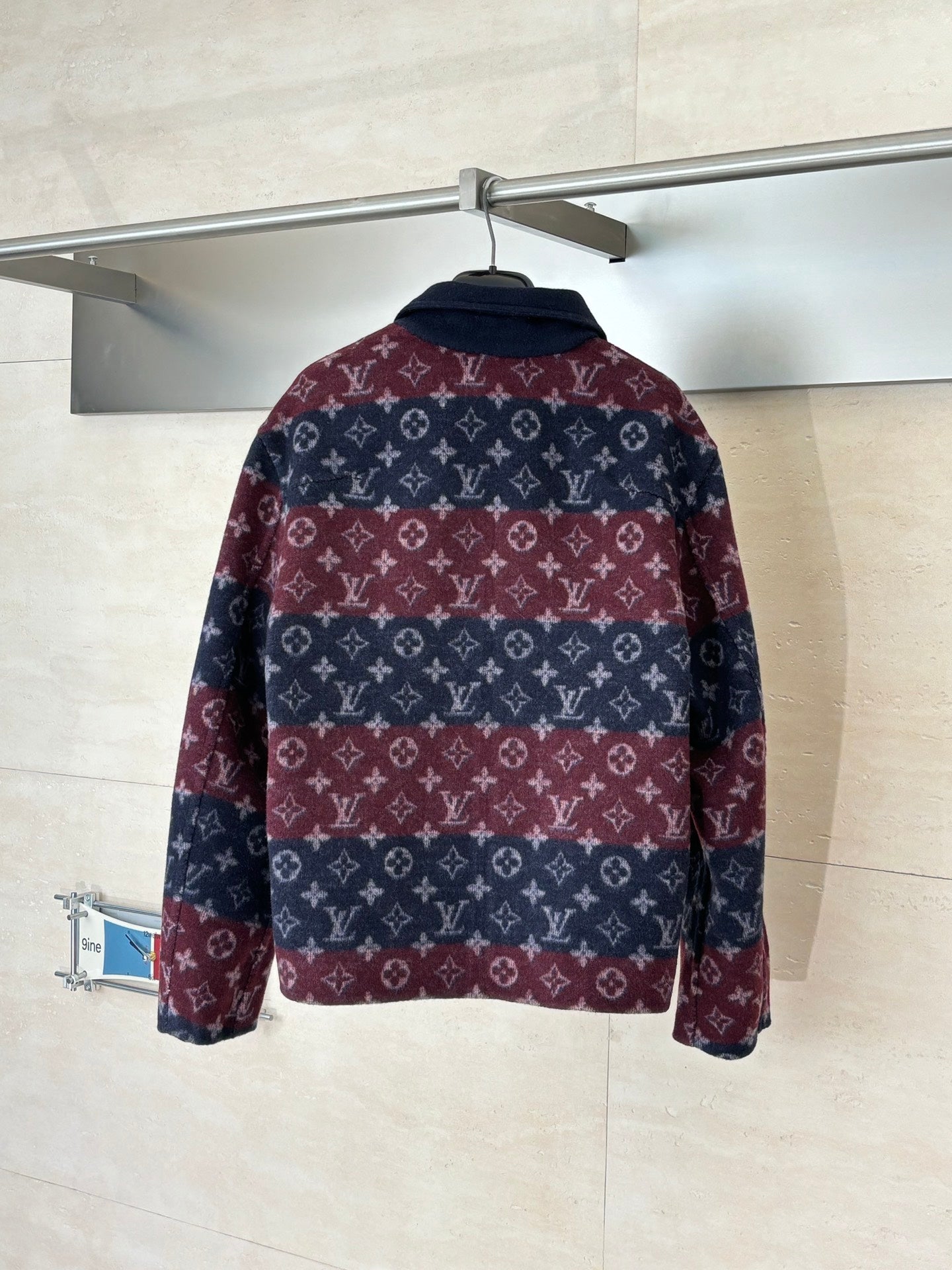 Long Louis Vuitton jacket with maroon and navy monogram pattern, back view, stand collar.