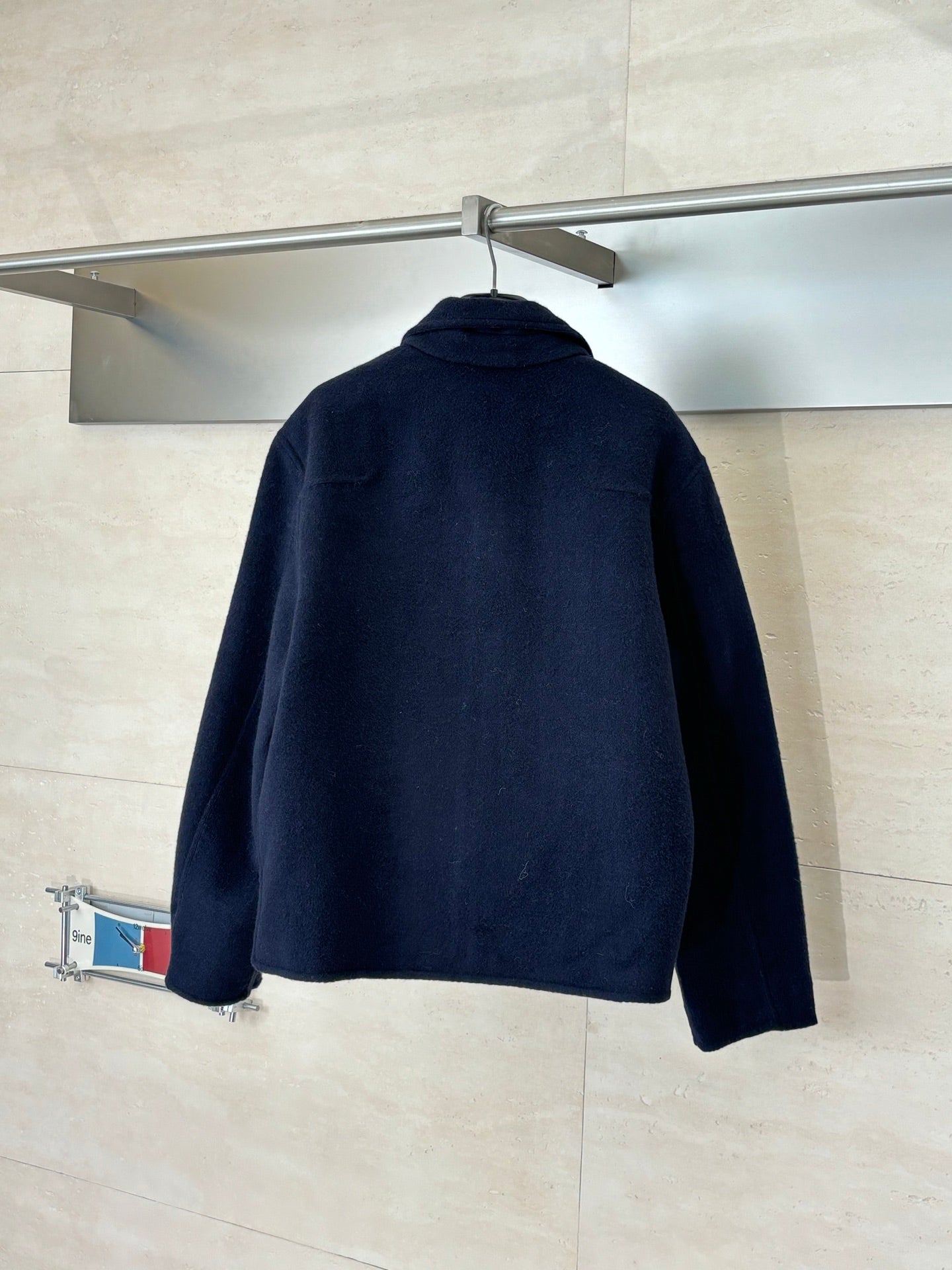 Long Louis Vuitton jacket in dark navy, back view with stand collar and full-zip.