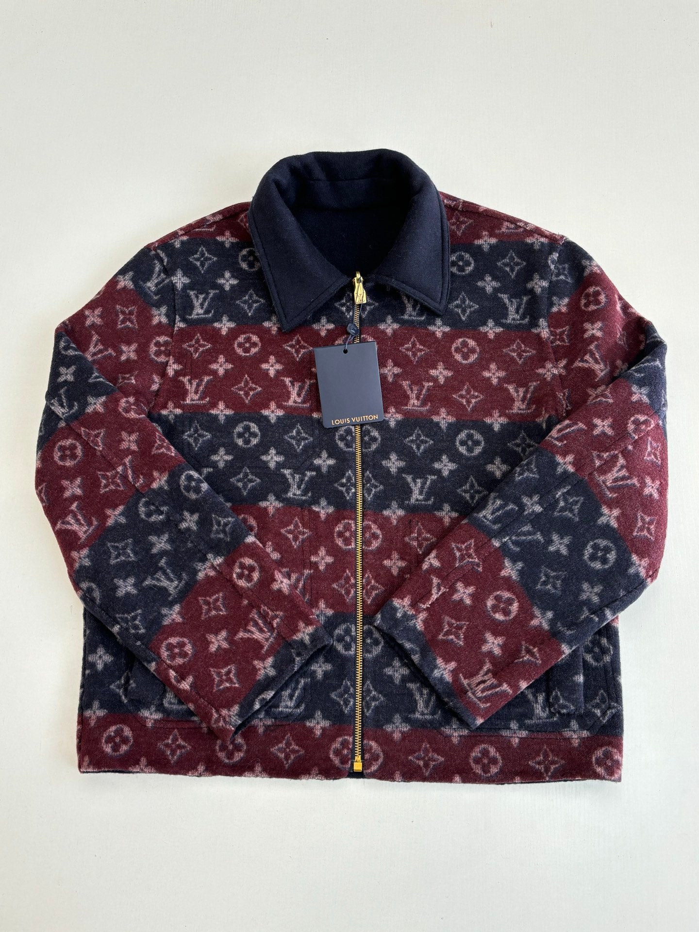 Monogram Louis Vuitton jacket with stand collar and gold zipper, maroon and navy.