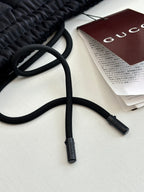 Navy track pants drawstrings with Gucci hang tag