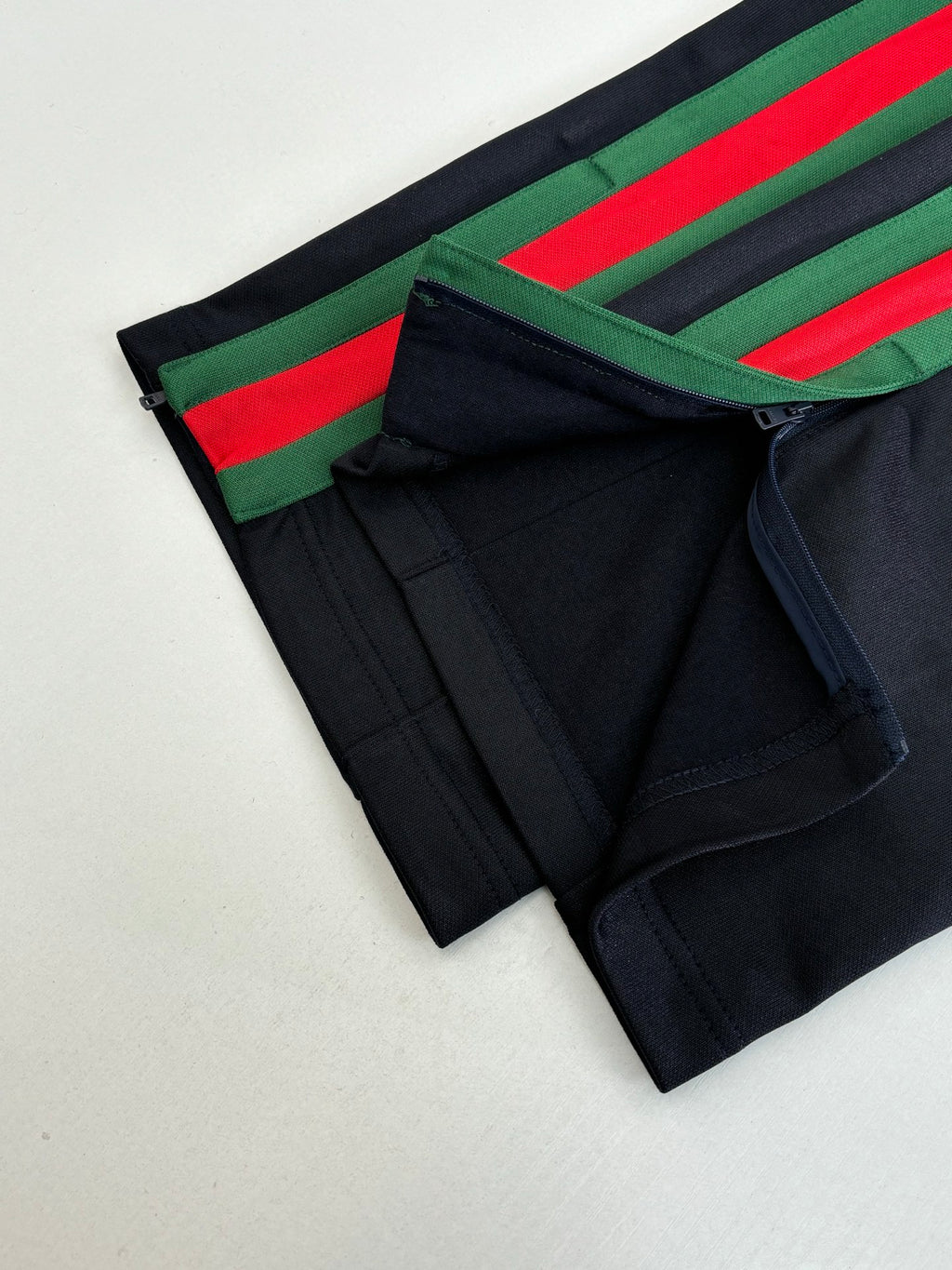 Navy shorts with green and red side stripe tape and front pocket seam