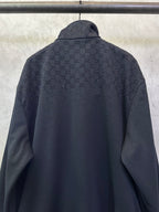 Dark Gucci zip-up jacket back with monogram pattern and stand collar
