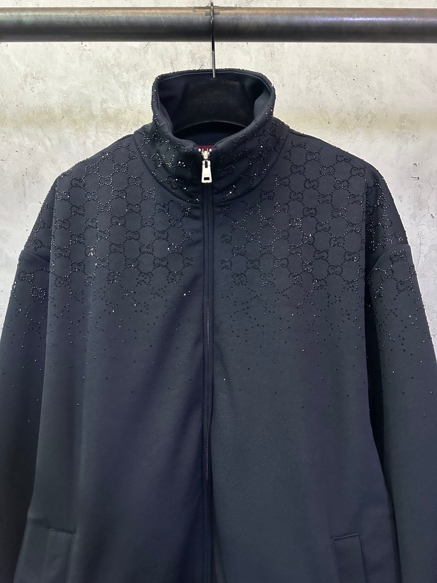 Dark Gucci zip-up jacket with monogram pattern, stand collar and silver zipper
